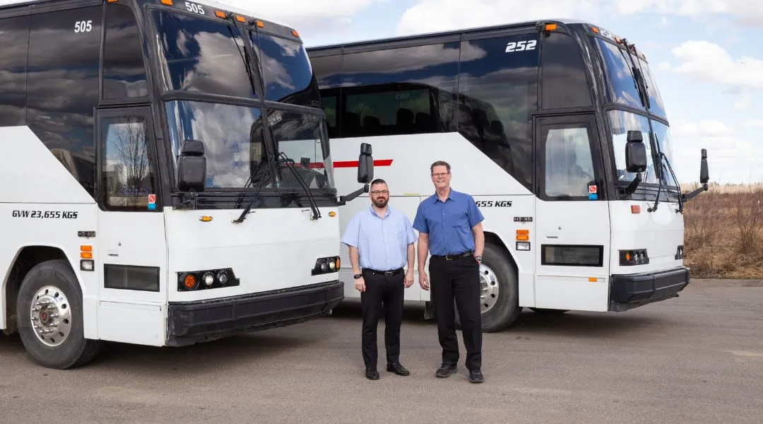 Go Coach Charters team in front of two coaches